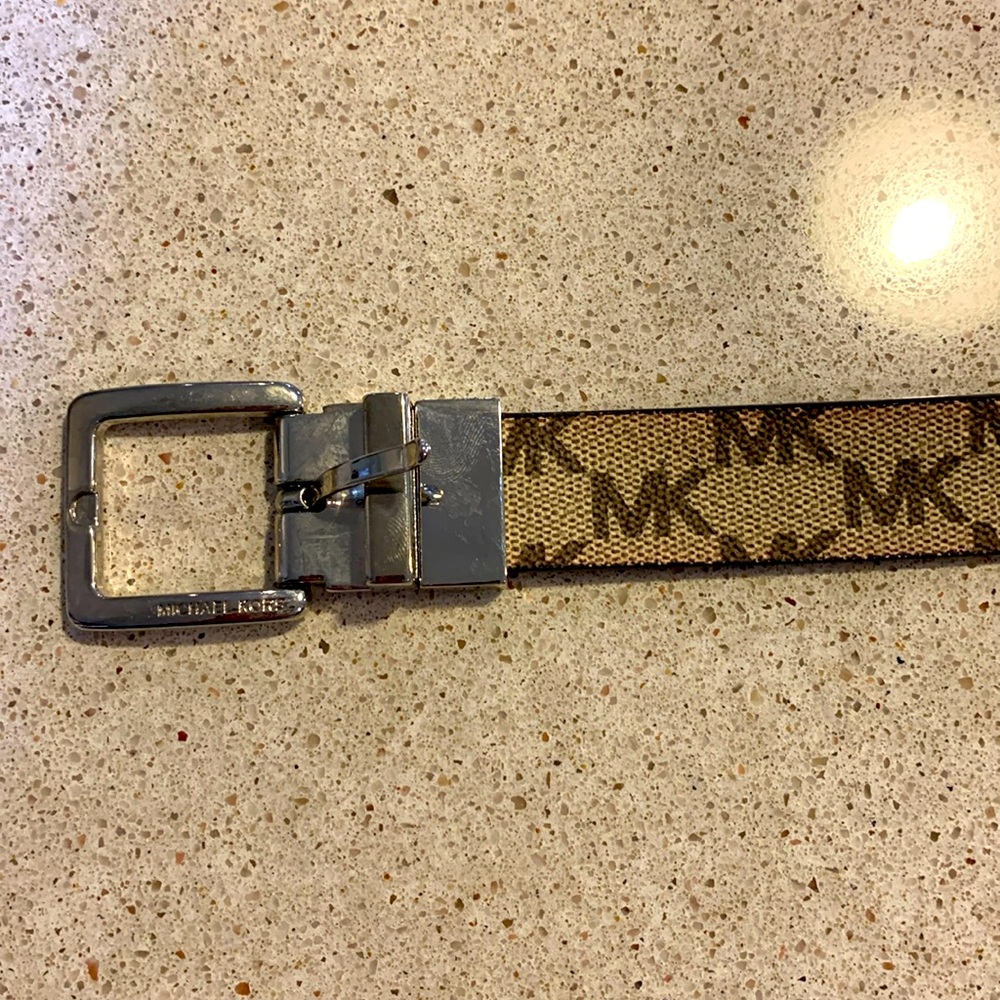 Michael Kors women’s brown initialed MK belt with camel colored strip.